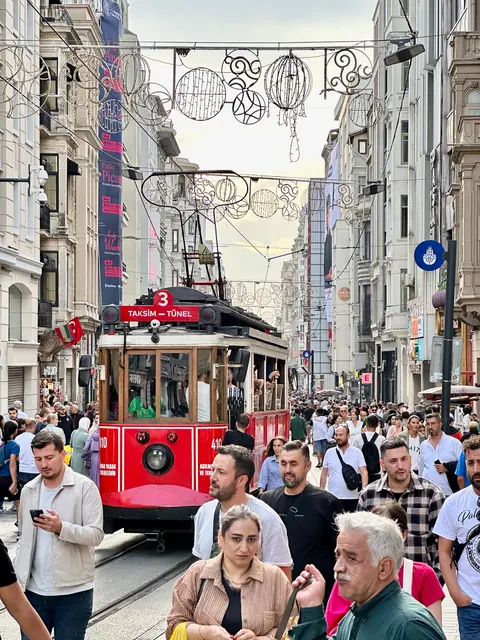 A red tram on a crowded shopping street, Turkey