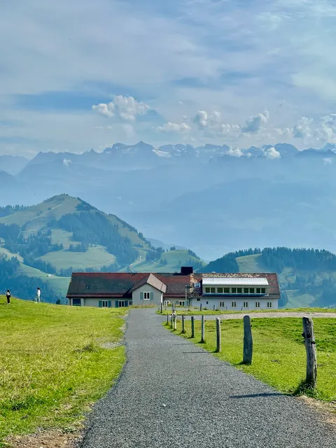 A path through green fields toward the mountains, Switzerland