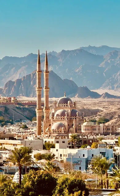 A mosque beneath rugged mountains, Egypt