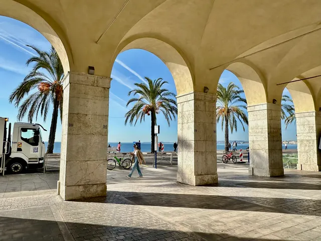 Palm trees framed by stone arches, France