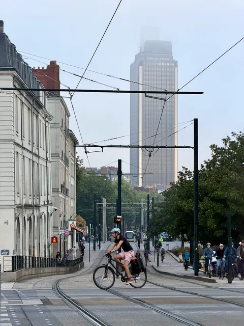 A cyclist passing modern city towers, France