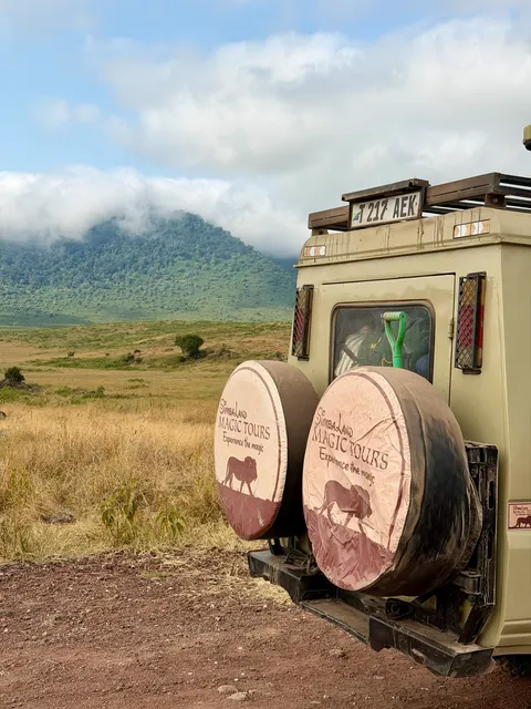 Safari vehicles on a dirt road, Tanzania