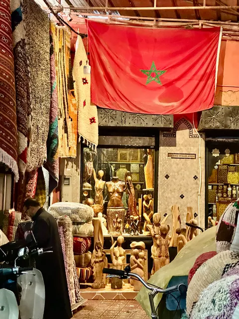 A market lane beneath red fabric, Morocco