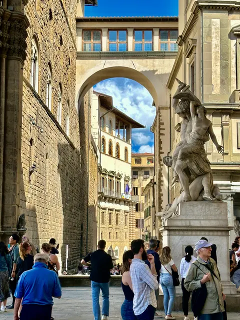 A statue framed by a stone arch, Italy