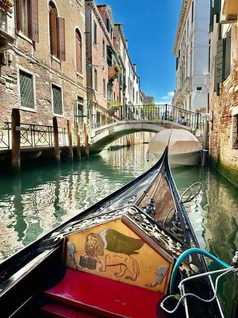 A gondola beneath a small bridge, Italy