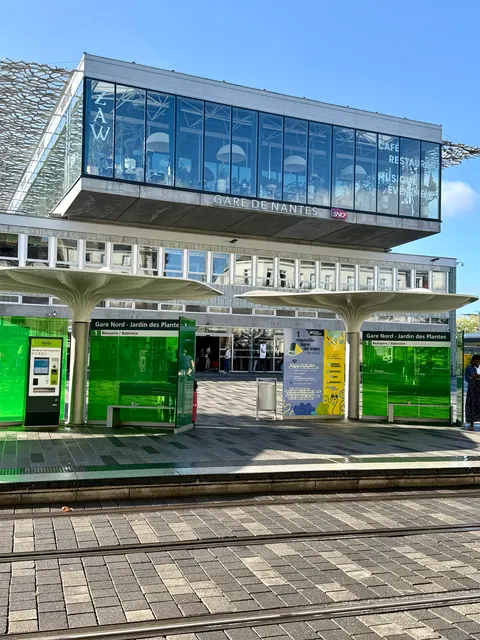 A modern glass building beside tram tracks, France
