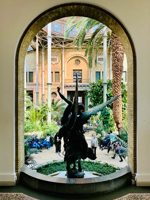 A fountain framed by a stone arch, Denmark