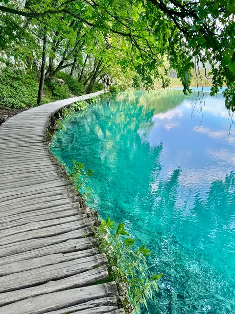 A wooden walkway along a clear lake, Croatia