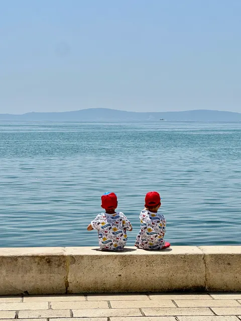 Two people sitting beside the sea, Croatia