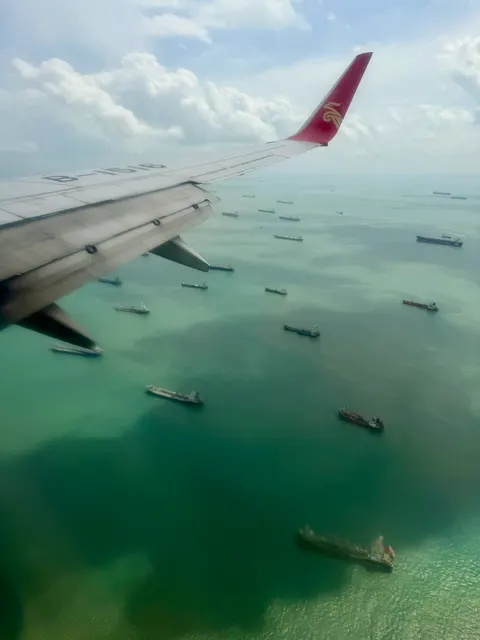 Ships below an airplane wing, Malaysia