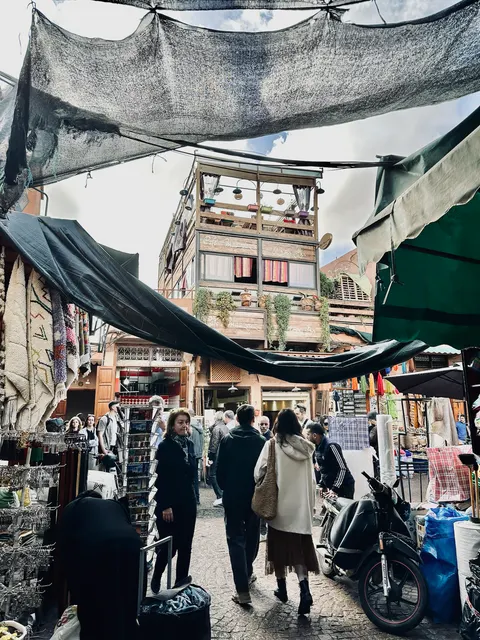 A busy market beneath shade cloth, Morocco