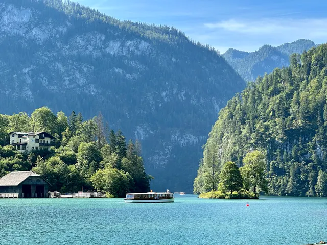 A lakeside pavilion beneath forested mountains, Germany