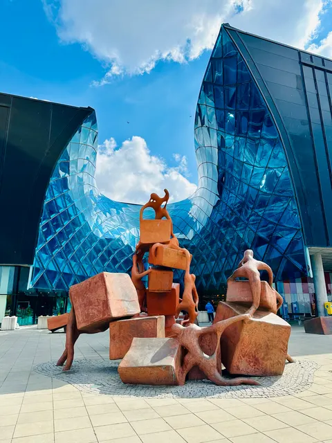 A blue modern building with outdoor sculptures, Sweden