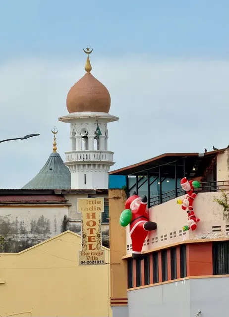 A mosque dome above neighborhood rooftops, Malaysia