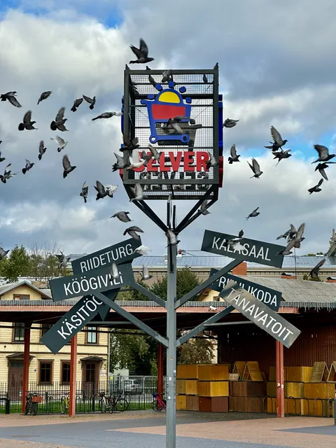 Signs and murals above a street corner, Estonia