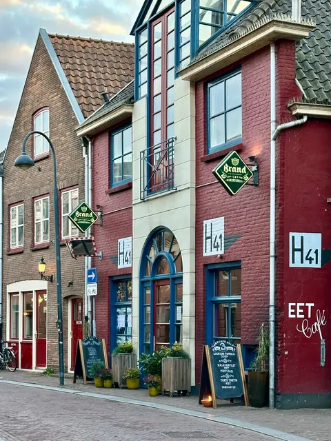 A brick house with colorful window shutters, Netherlands