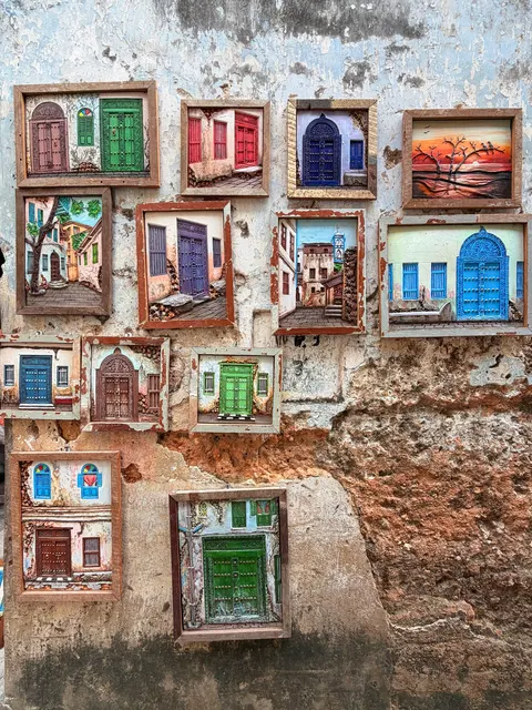 Painted windows on a weathered building, Tanzania