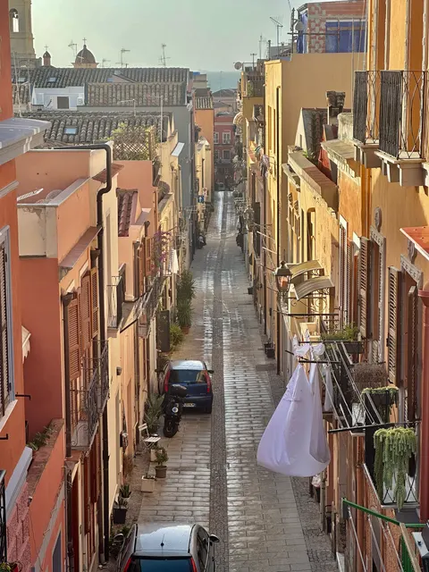 A steep lane between colorful houses, Italy