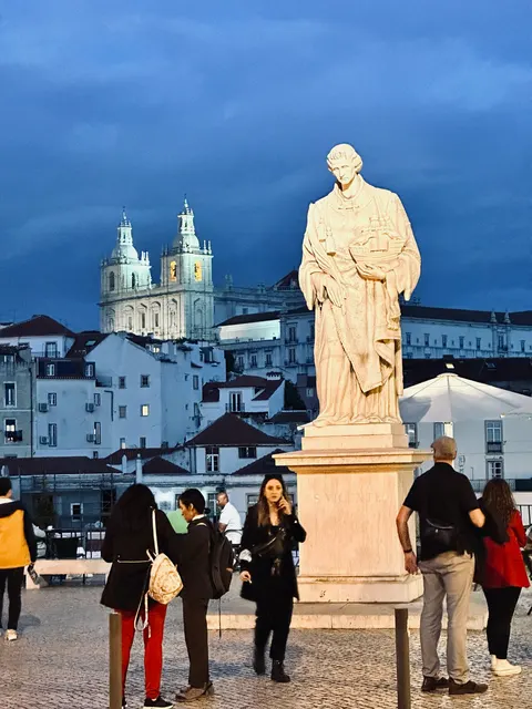A statue overlooking Lisbon’s rooftops, Portugal