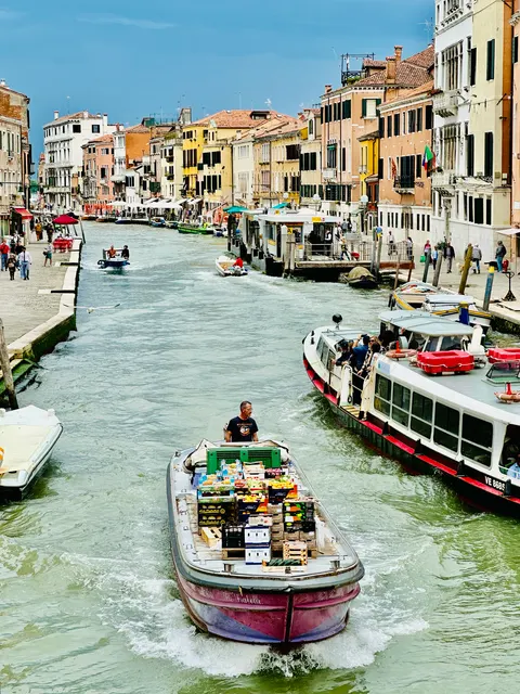 A busy canal lined with colorful buildings, Italy