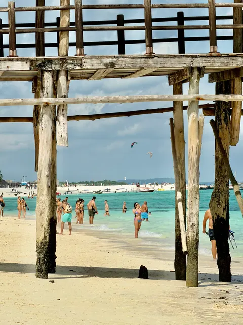 A beach framed by wooden posts, Tanzania