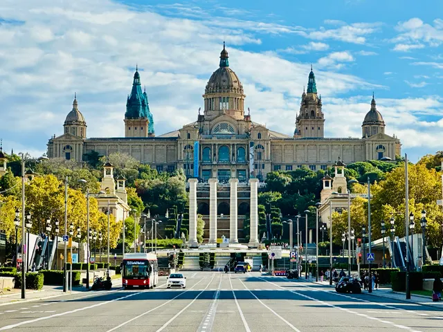 An ornate building above a broad avenue, Spain