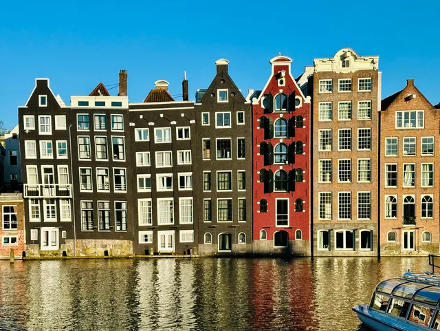 Canal houses reflected in still water, Netherlands