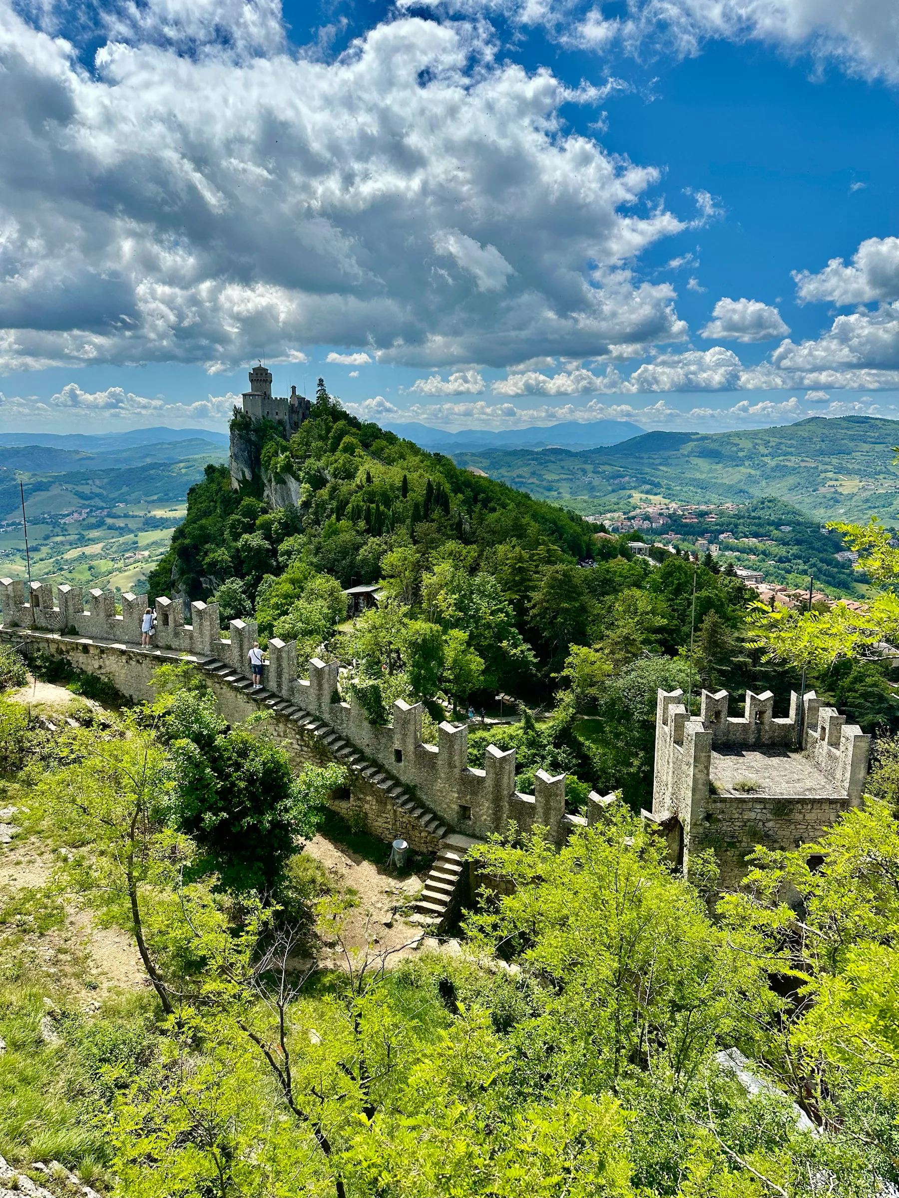 A hilltop tower above green countryside, San Marino