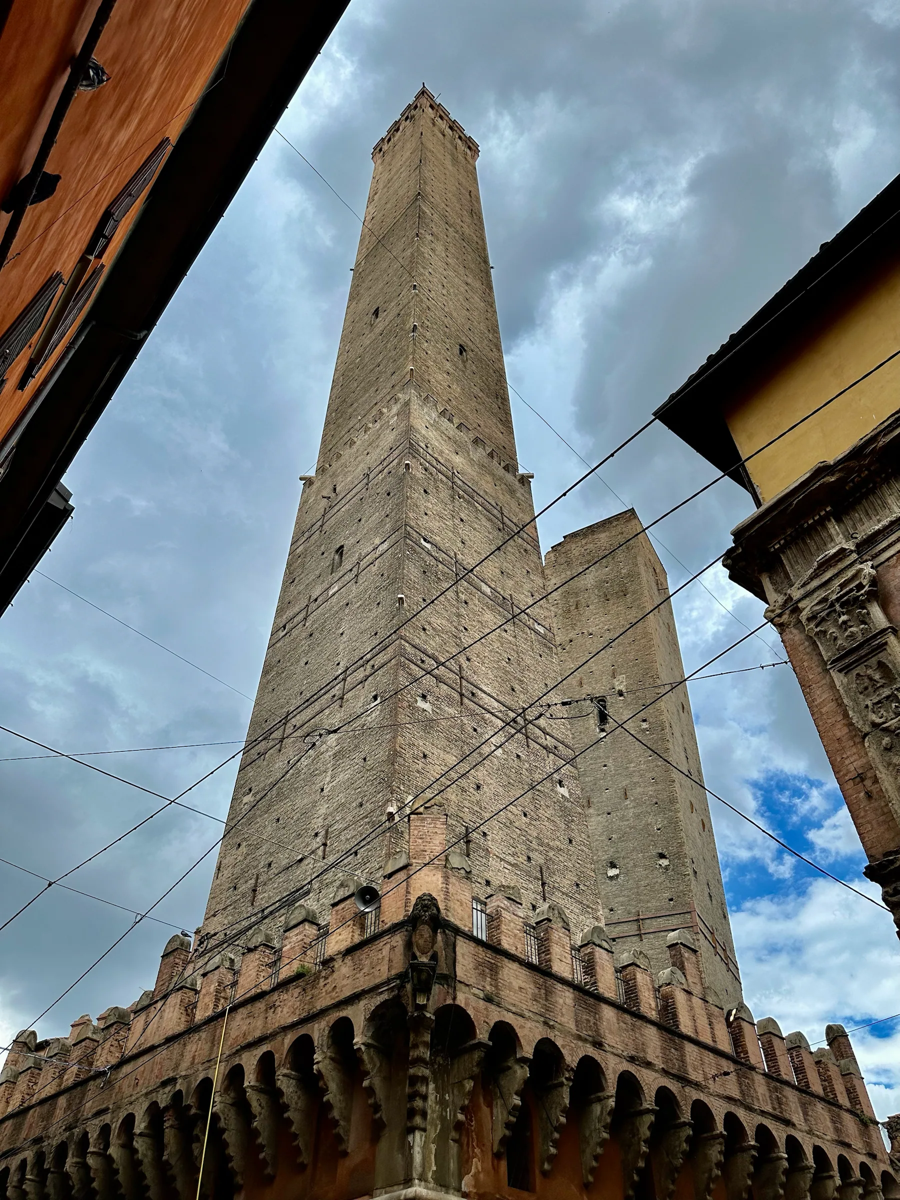 A stone tower beneath a cloudy sky, Italy