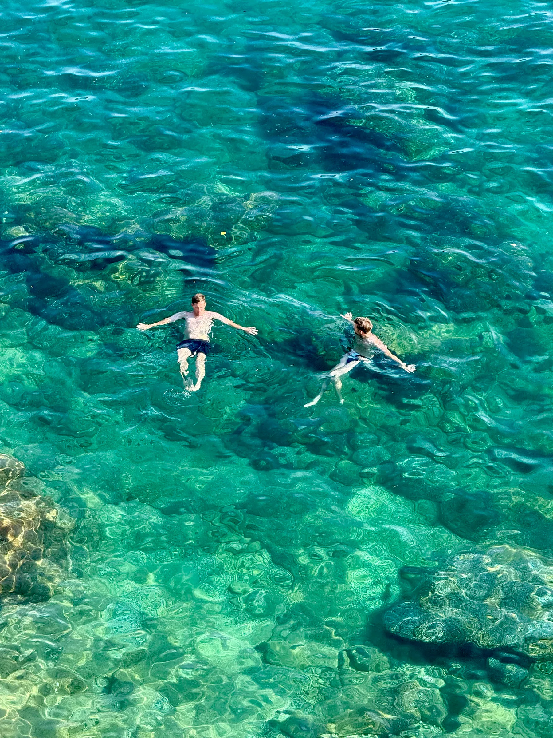 Swimmers in clear turquoise water, Croatia