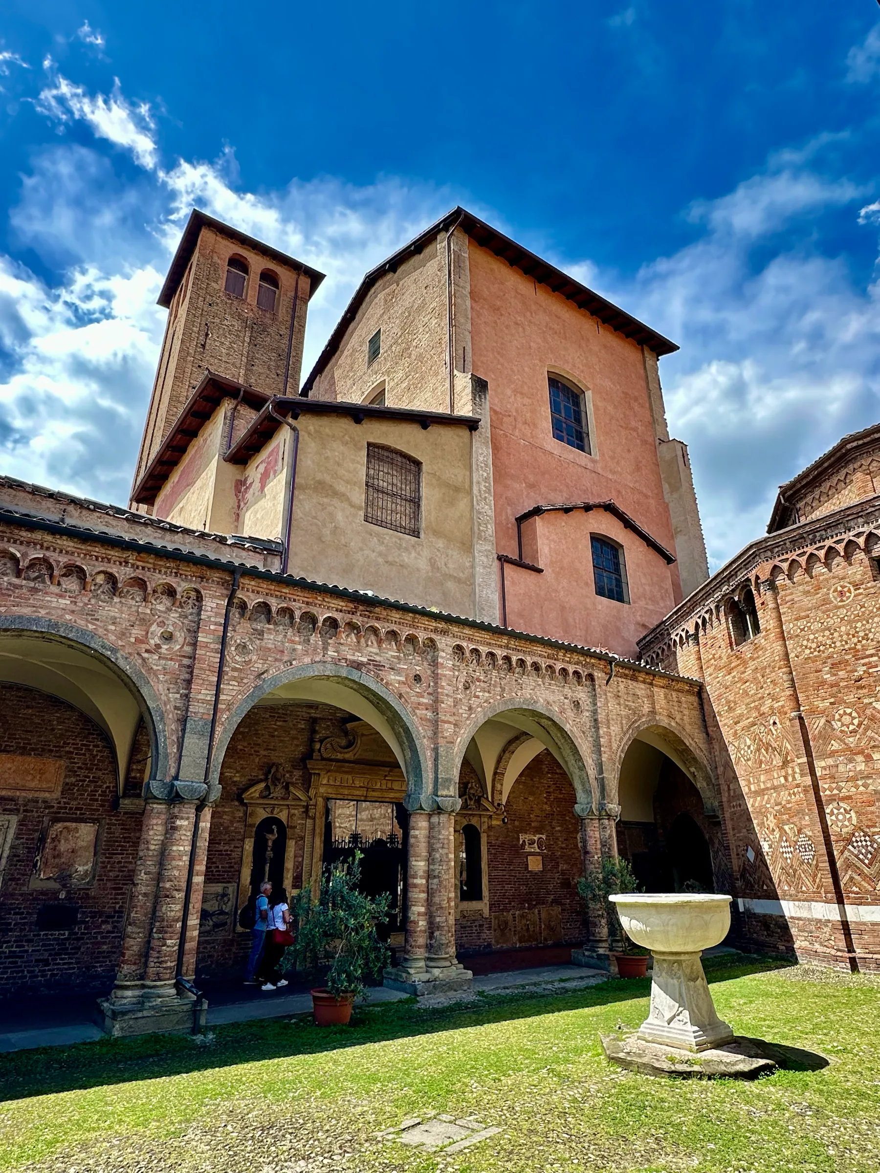 A courtyard with brick arcades, Italy