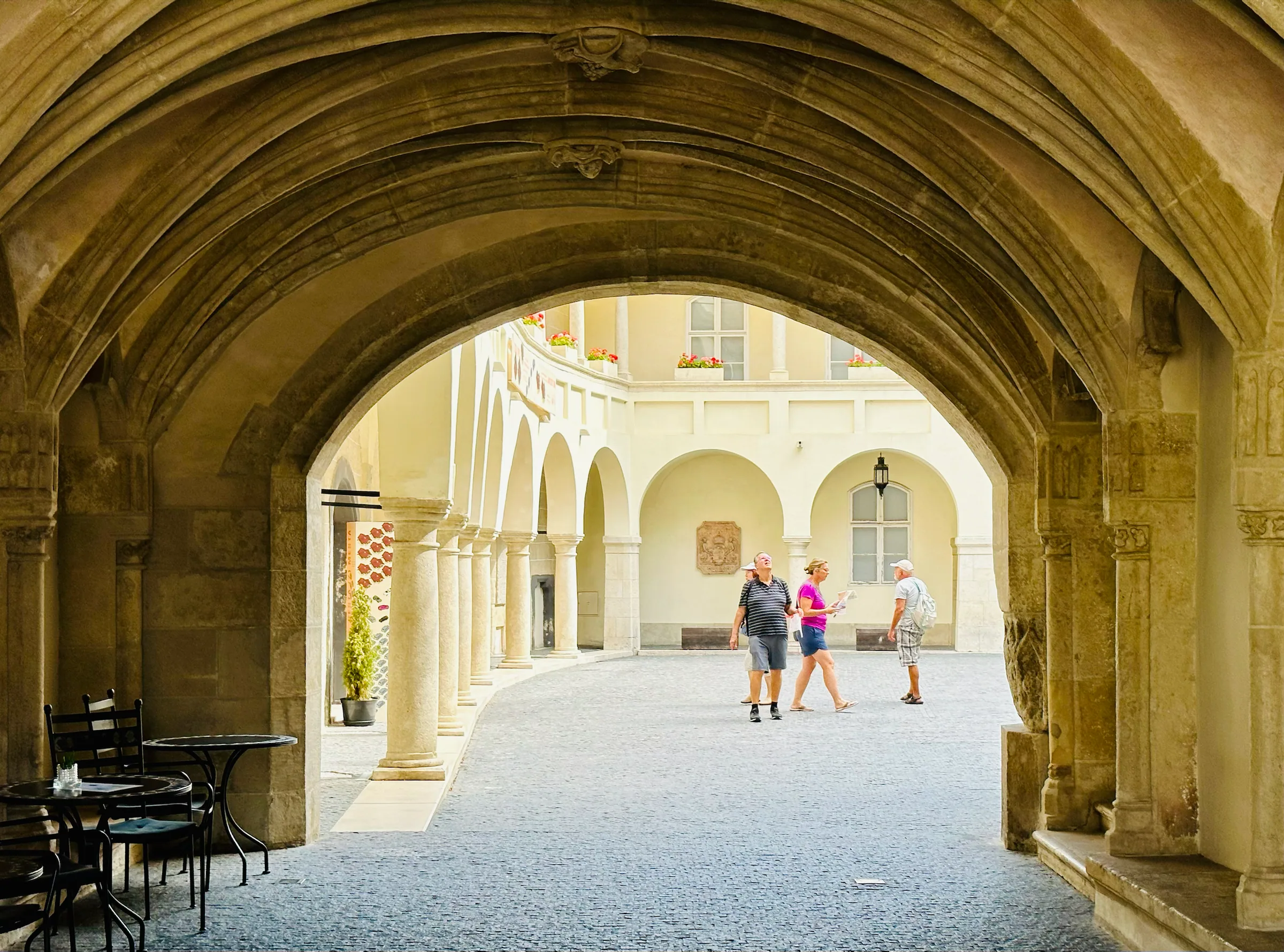 A sunlit courtyard beyond a vaulted passage, Slovakia